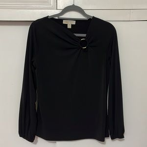 Michael Kors black blouse with gold circle feature. Size Medium